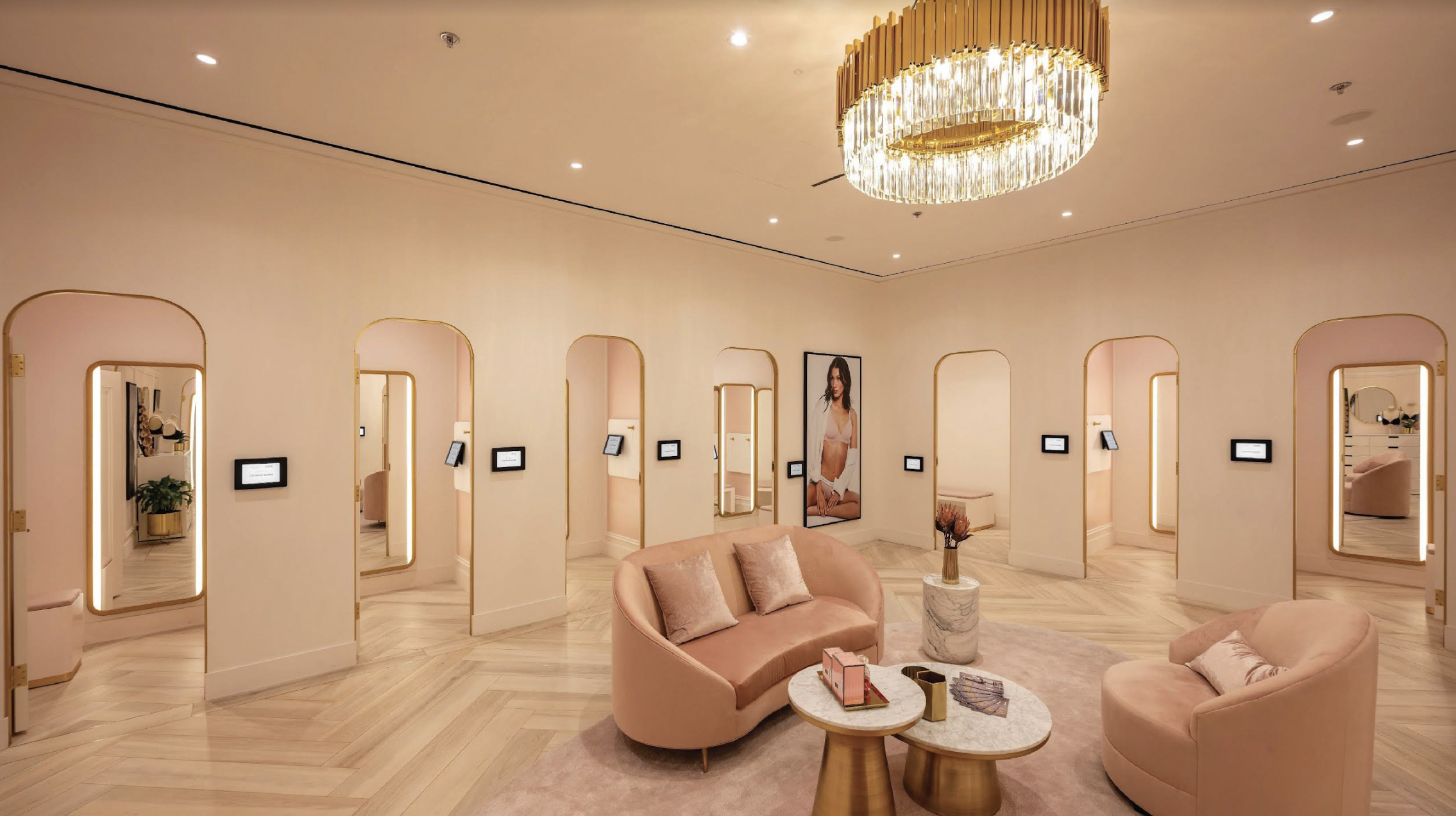 A luxury fitting room lounge with Crave touchscreens at the entrance of every room