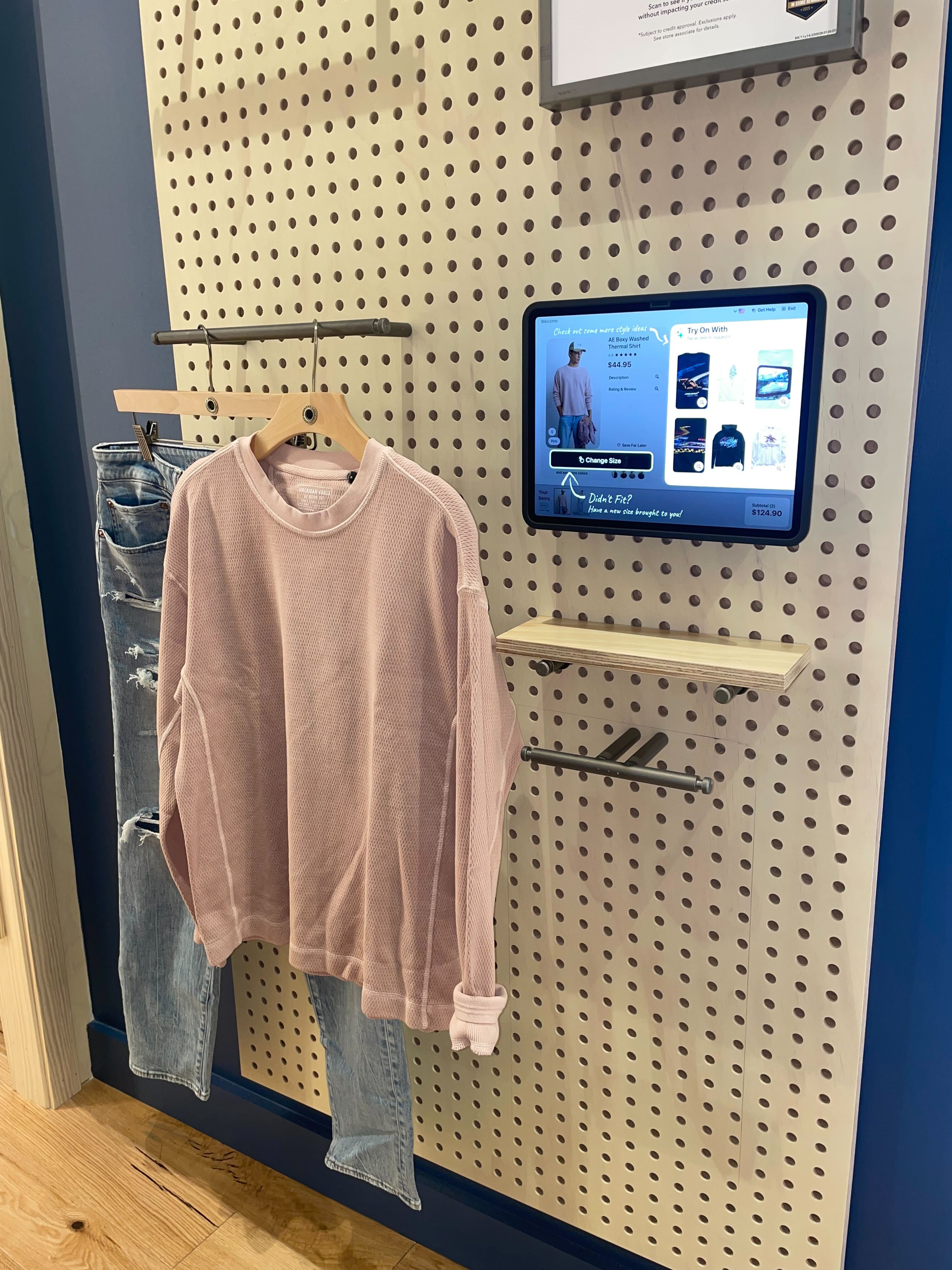 Inside a Crave smart fitting room with the in-room touchscreen and a shopper in motion.