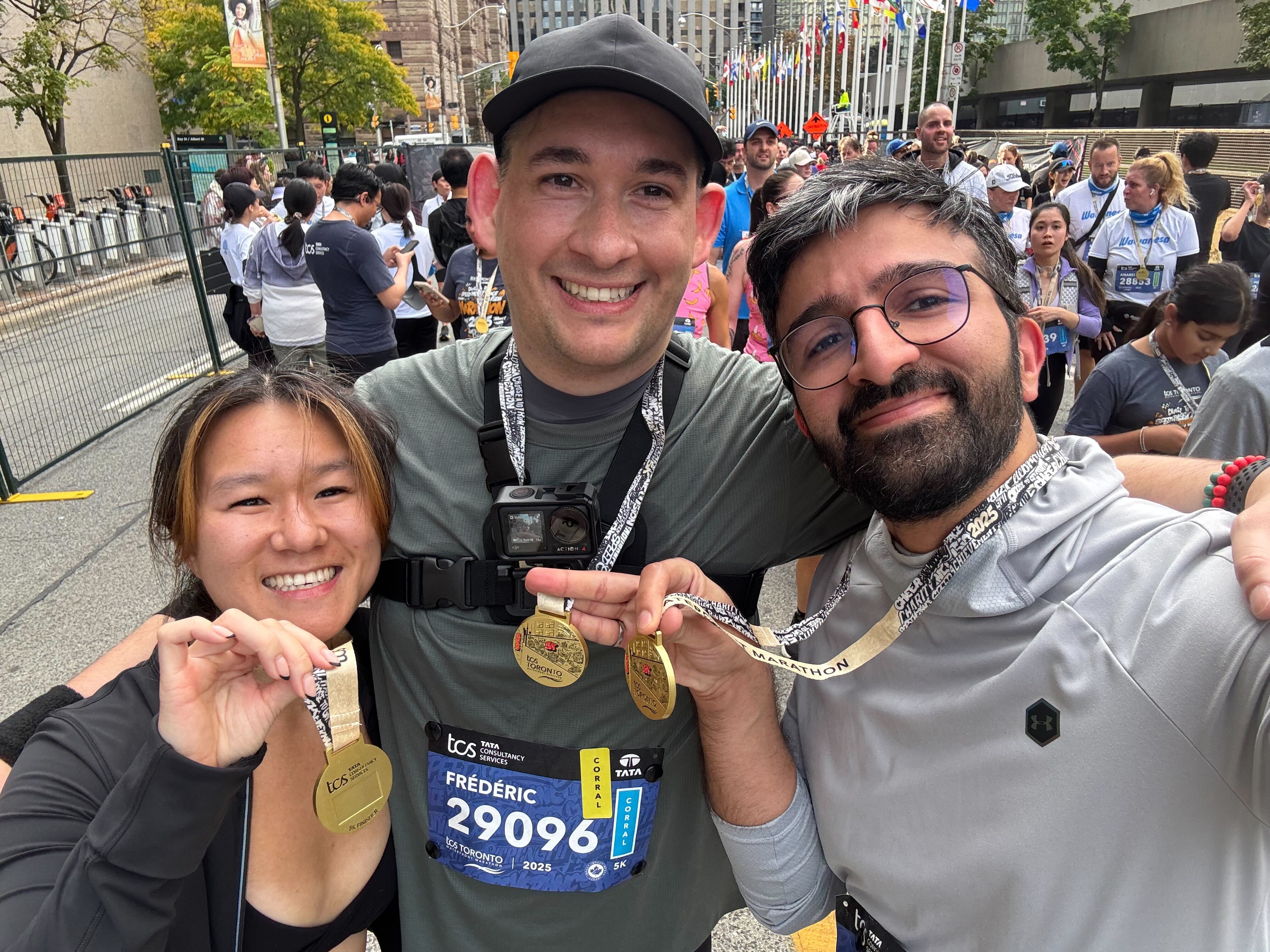 Three Crave team members smiling with finisher medals at the Toronto Waterfront Marathon